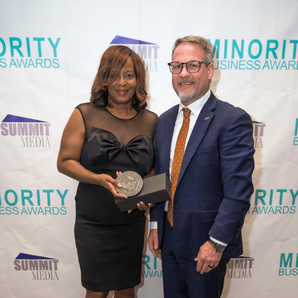 Dr. Carolyn Russell-Walker receives Academic Leader Award at the Minority Business Awards. Award was presented to her by Kevin Morris, AmFirst President and CEO.